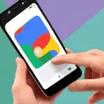A photo of a hand reaching toward a smartphone to change the profile picture on the Google app